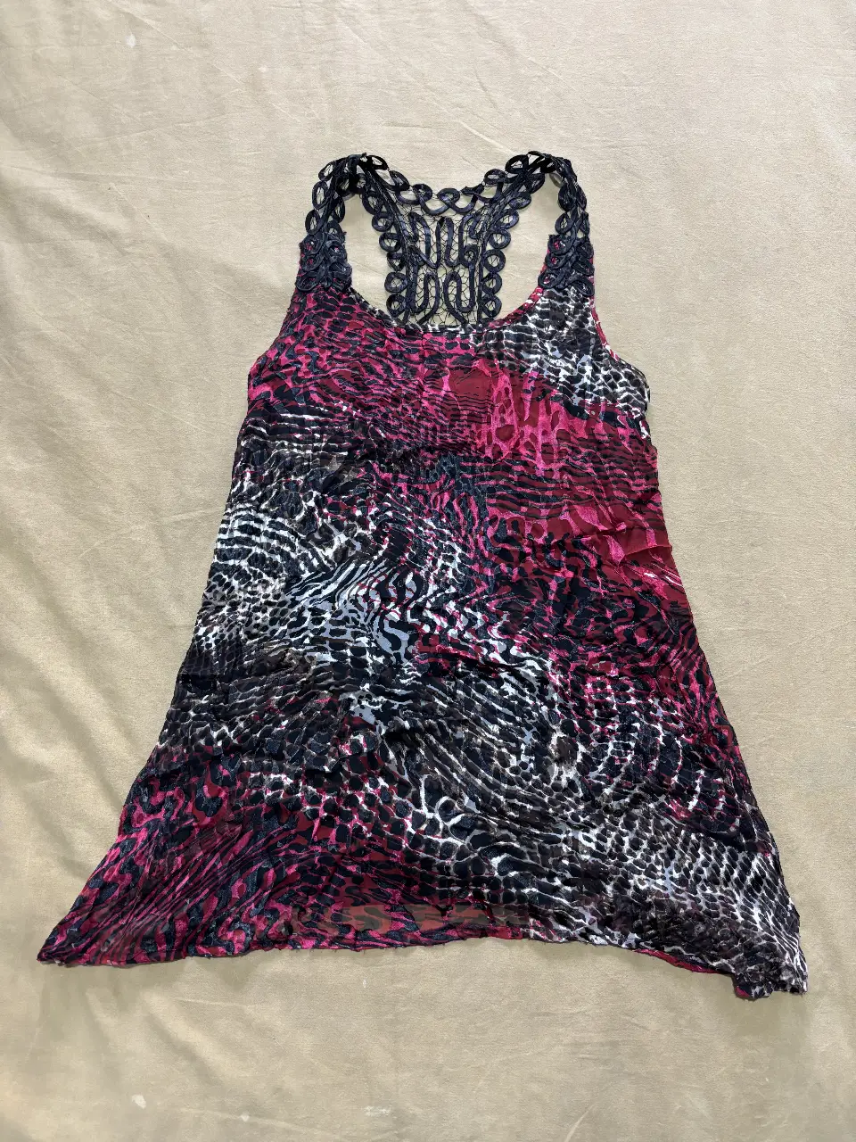 Vestido de mujer con estampado animal print en tonos rojo y negro. Detalles de encaje en la espalda y breteles. Ideal para un look de fiesta.