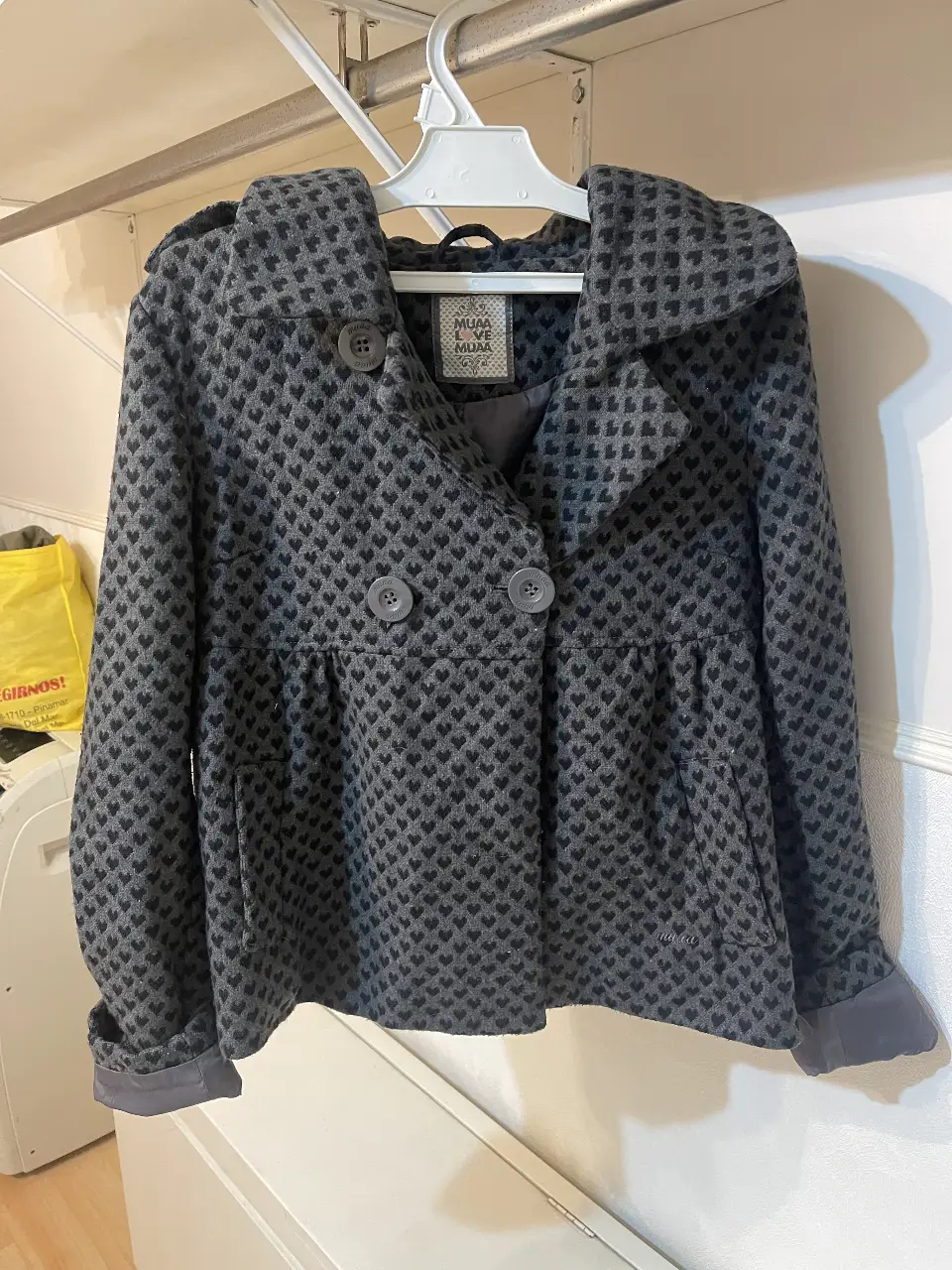 Campera de mujer con diseño de corazones en relieve. Corte entallado, con botones y capucha. Ideal para un look casual y abrigado.