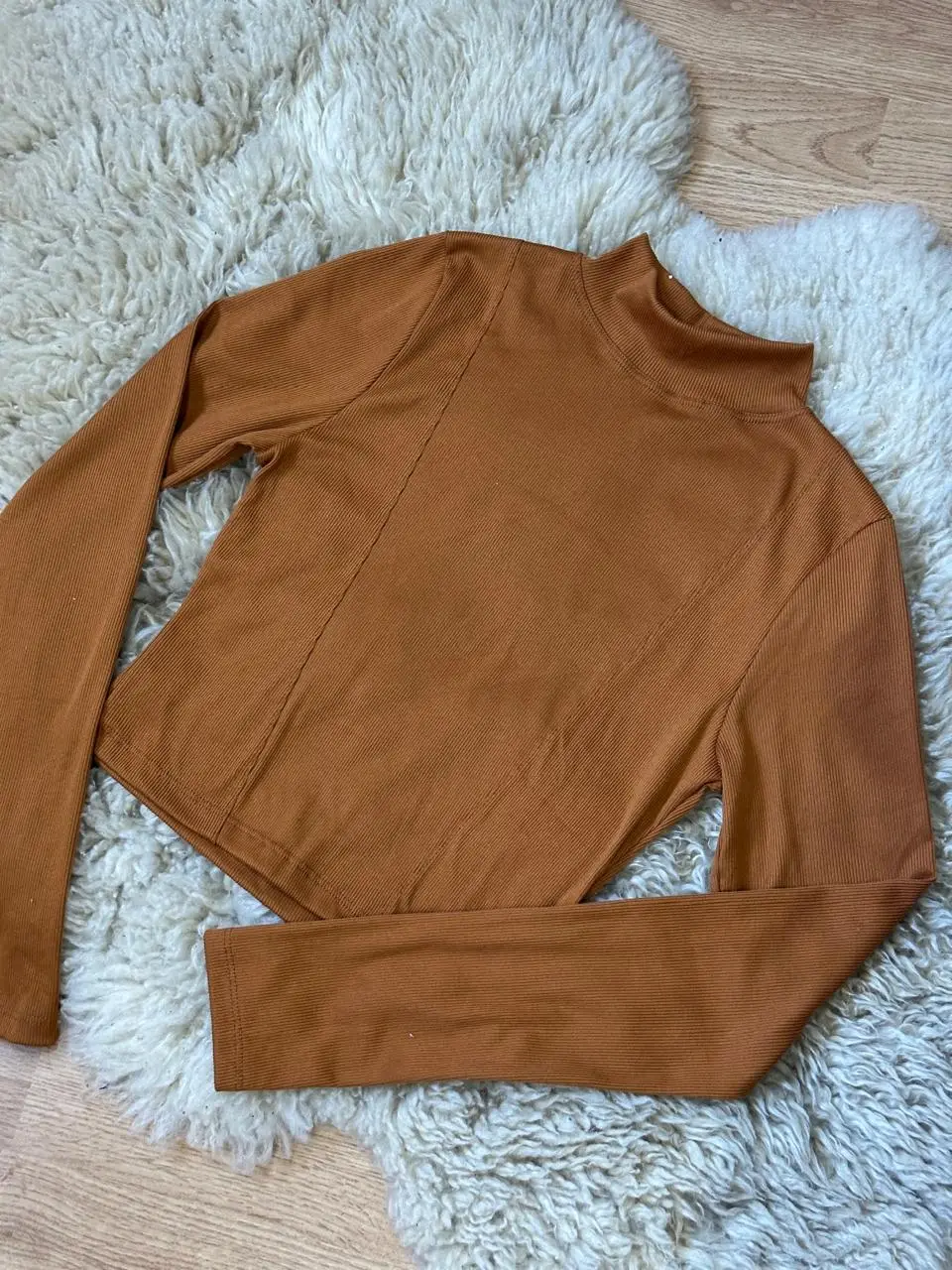Remera manga larga de cuello alto en color marrón. Ideal para un look casual y moderno. Confeccionada en tejido de punto suave y cómodo.