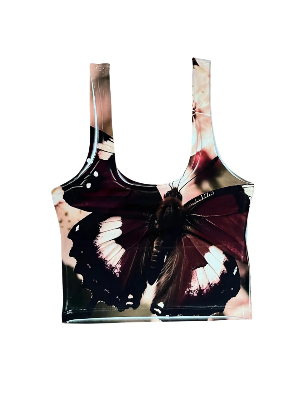 Musculosa crop con estampa de mariposa y flores en tonos oscuros y blancos. nuevo. talle xs/s. lycra sublimada. medidas sisa 36 a 40 cm. largo 44 cm.