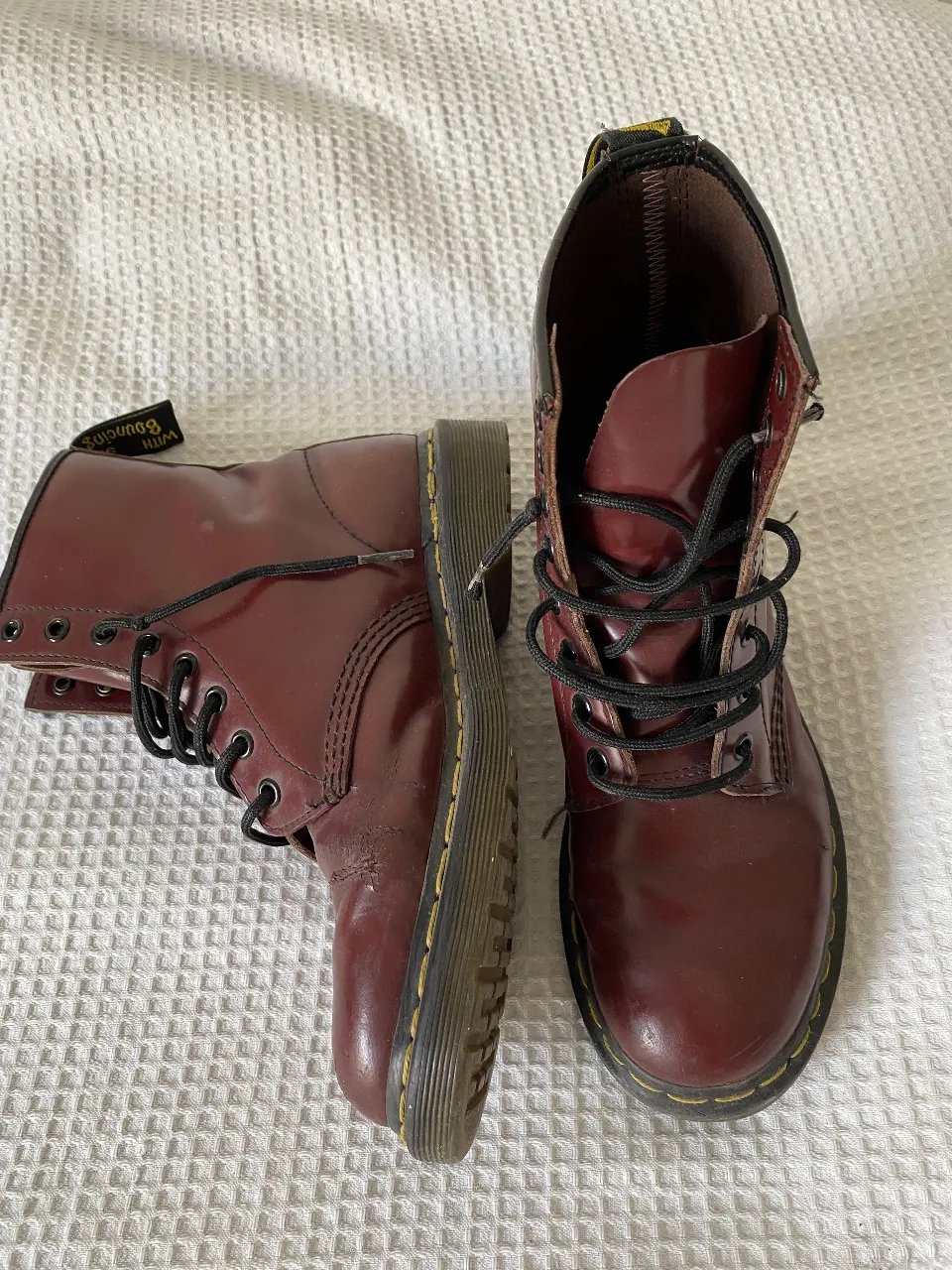 Borcegos Dr. Martens color bordó, con cordones negros y suela amarilla. Tienen detalles de costuras y la etiqueta de la marca. Ideales para un look urbano y con estilo. detalles de uso como se ven en las fotos, son muy cómodos.