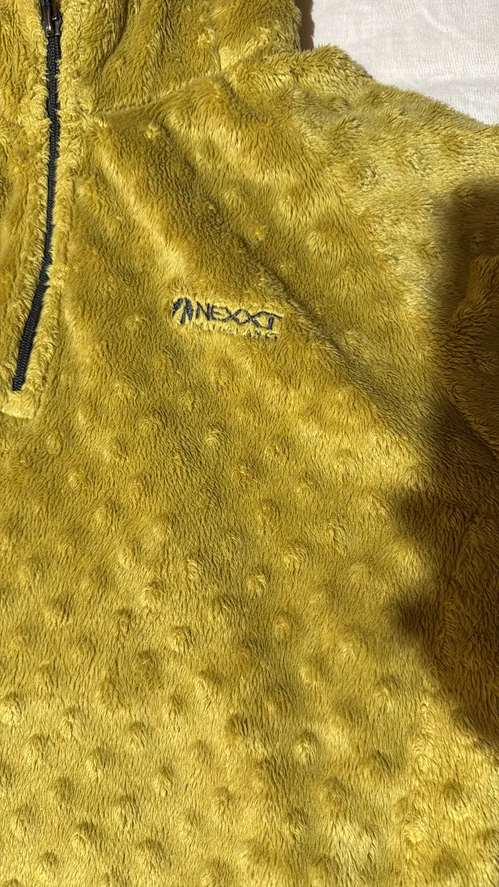 Buzo con cierre y capucha, de tela tipo polar, color amarillo. Ideal para el invierno.