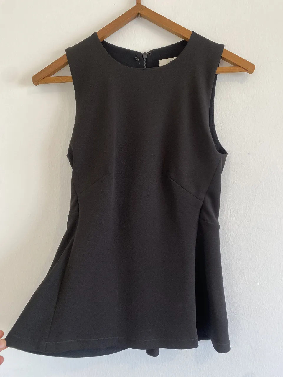 Top negro de mujer, sin mangas, con corte en la cintura y cierre en la espalda. Ideal para una salida o evento formal. talle 1