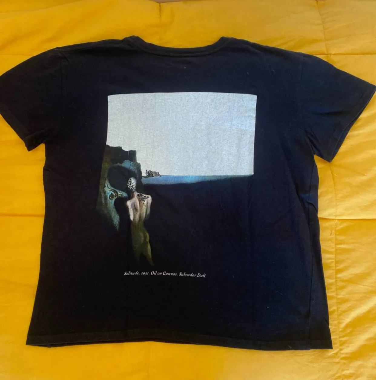 Remera negra de algodón con estampado artístico de Salvador Dalí. Diseño único y original, ideal para un look casual y con estilo.