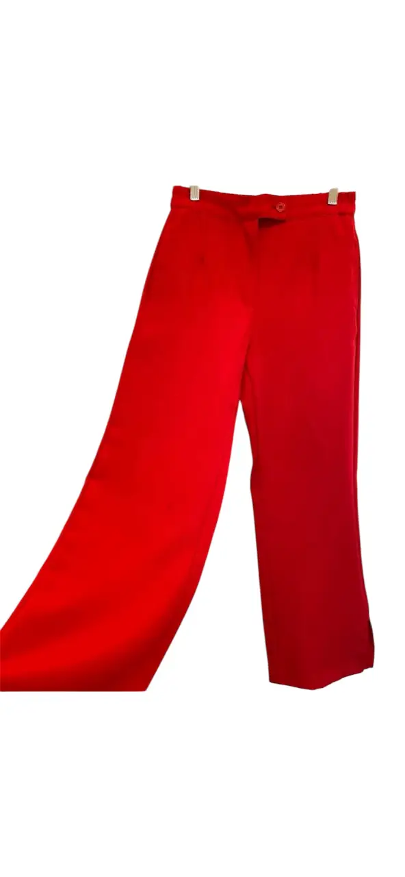 Pantalón sastrero rojo, con corte amplio y detalle de abertura en el bajo. Talle 00/36. cintura 36/40, cadera a la altura del tiro 47, tiro delantero 29, tiro trasero 36, ancho muslo a la altura del tiro 31, largo 106