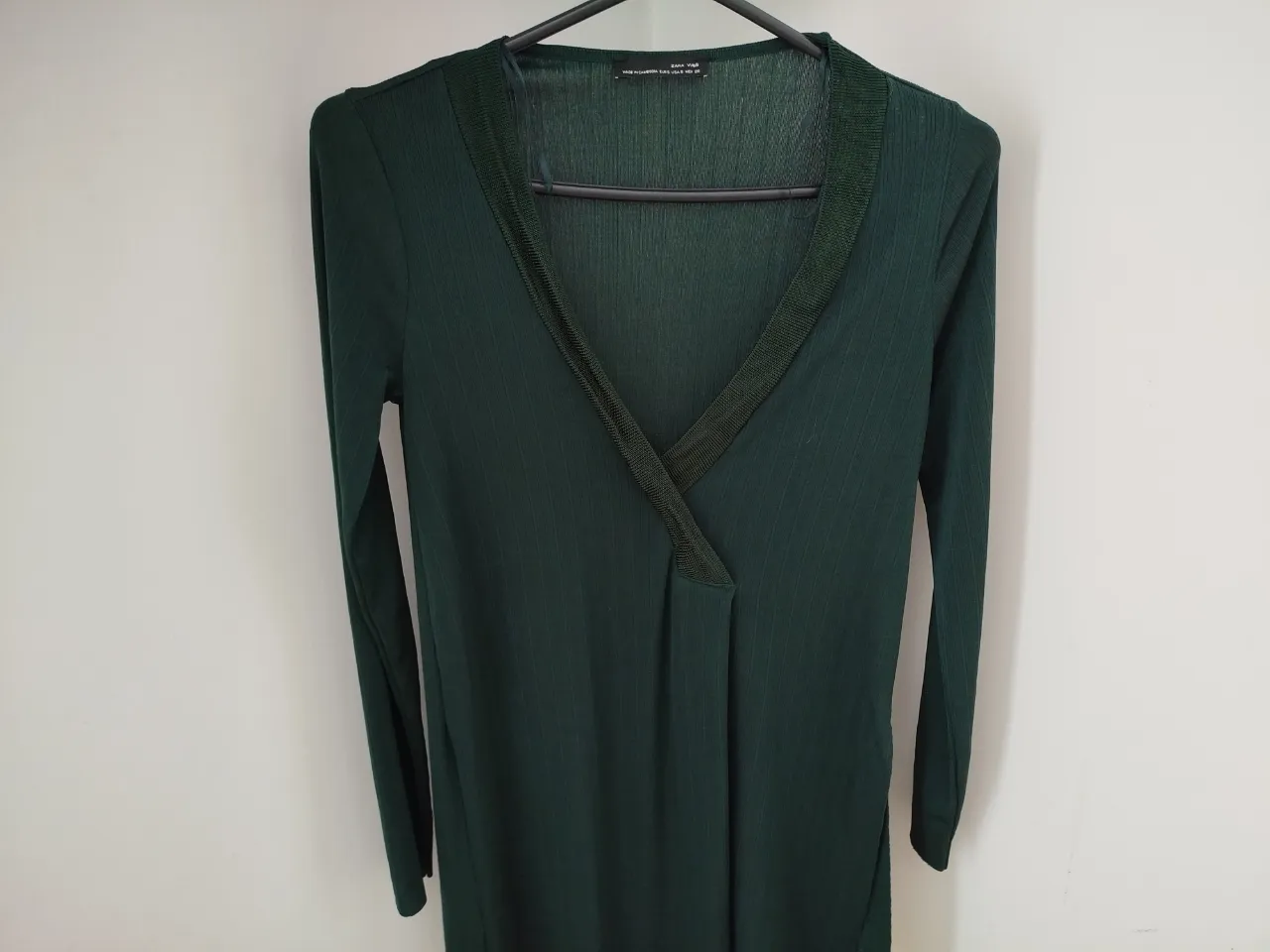 camisola larga en color verde oscuro, con manga larga y cuello en V. tajos a los costados. Marca Zara. Ideal para un look elegante y versátil.