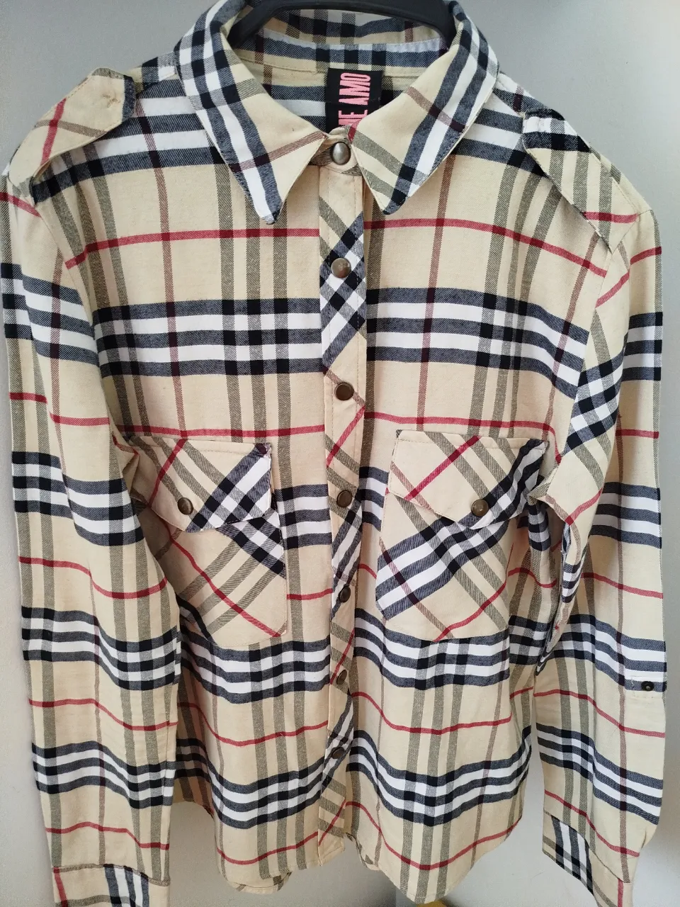 Camisa a cuadros en tonos crudos, negros y rojos. Ideal para un look casual y canchero. Perfecta para combinar con jeans o pantalones de vestir.