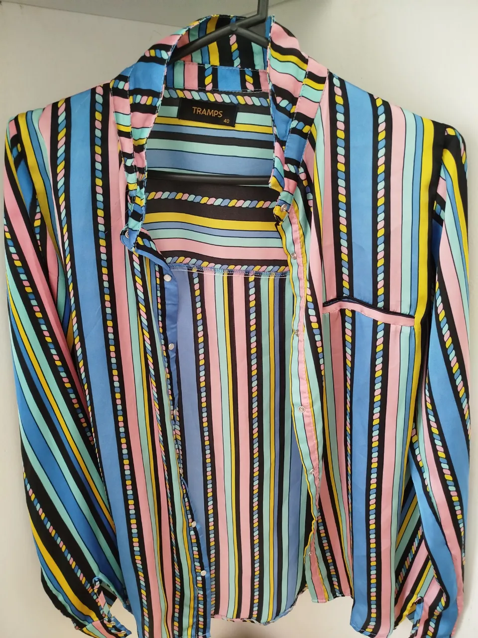 Camisa estampada a rayas con diseño vibrante y colorido. Ideal para un look moderno y llamativo. Confeccionada con un tejido suave y ligero, perfecta para cualquier ocasión.