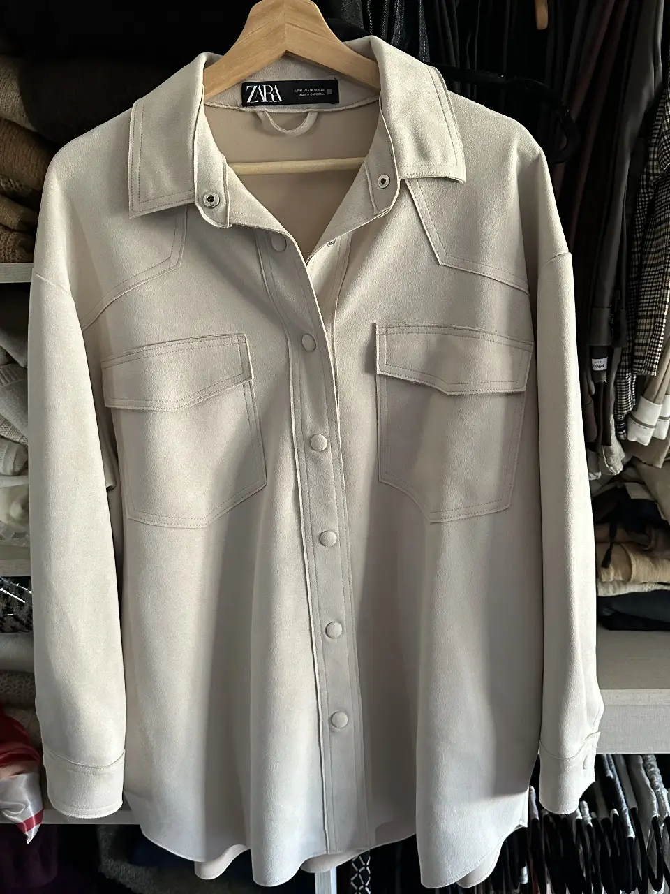 Camisa de mujer estilo sobrecamisa en color crudo, con dos bolsillos delanteros y botones. Ideal para un look casual y moderno.
