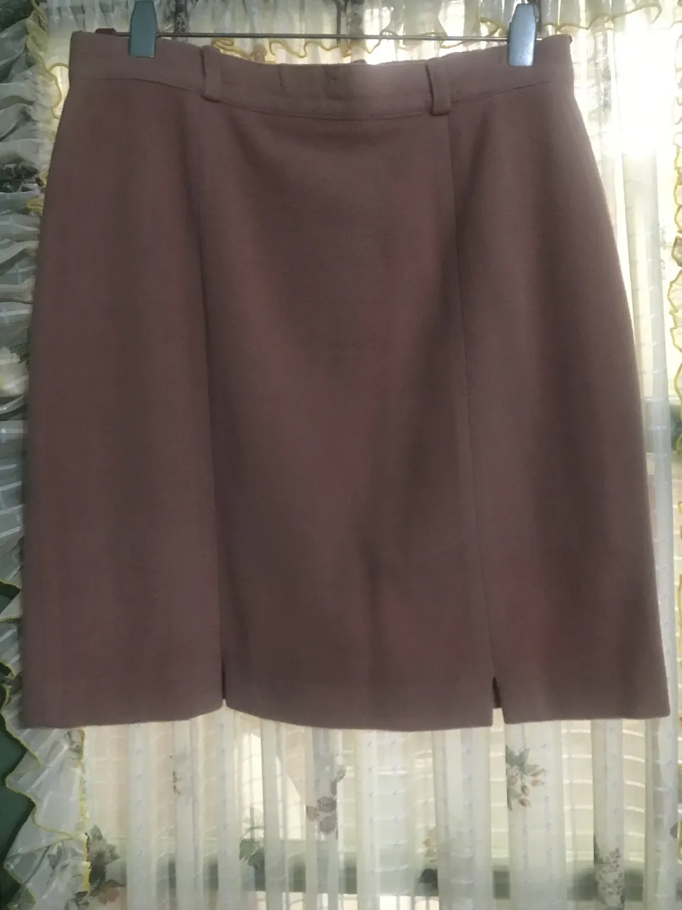 Pollera sastrera marrón con corte en la parte delantera. Ideal para un look formal o de trabajo.