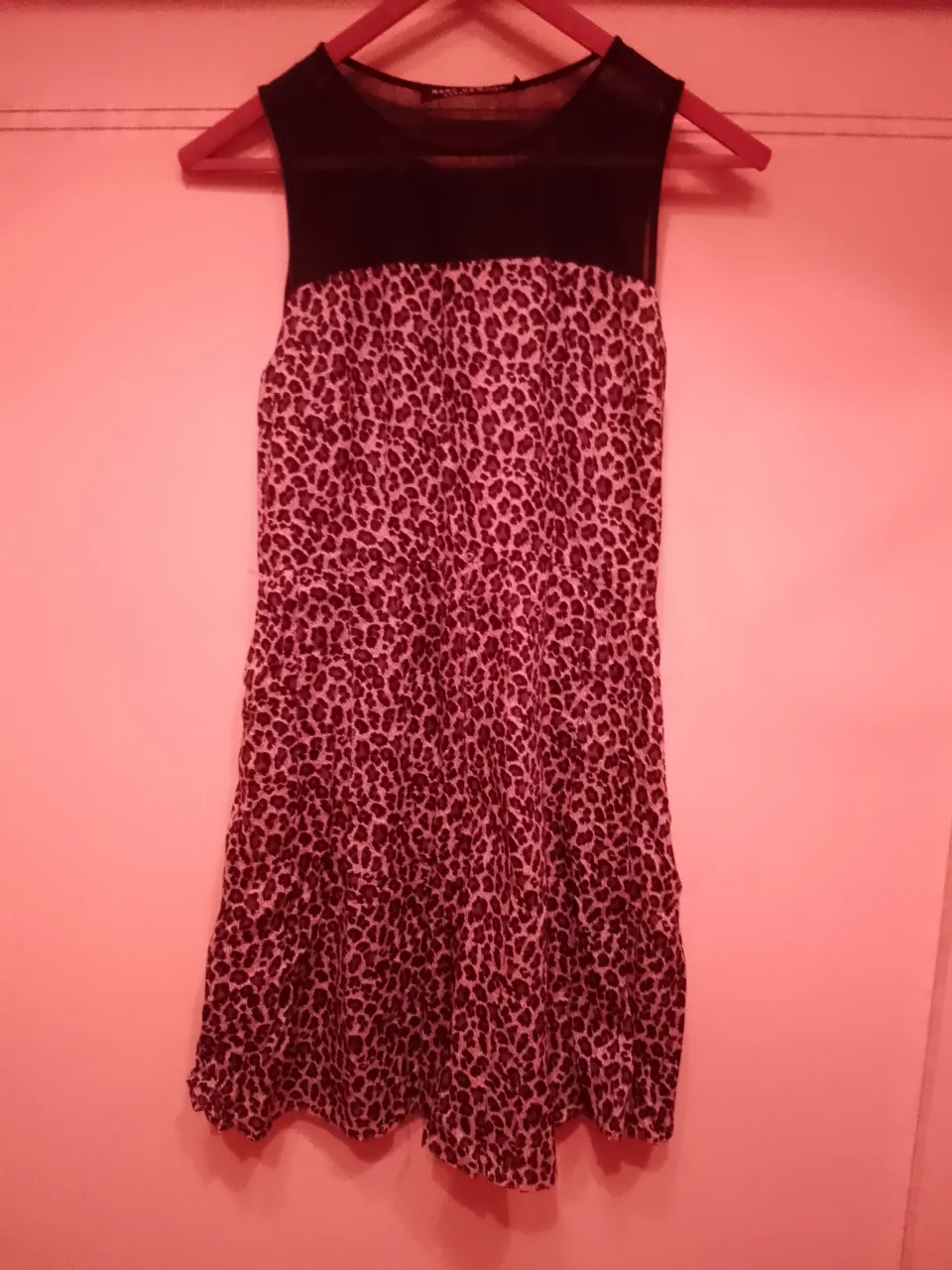 Vestido corto con estampa de leopardo y detalles en negro. Ideal para una salida o fiesta.