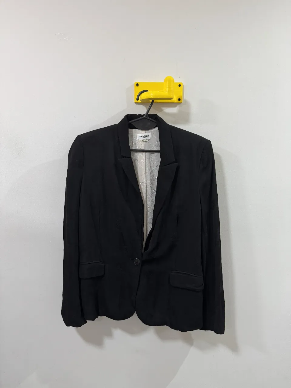 Blazer negro de mujer, con un solo botón y forro interior con estampado. Ideal para un look elegante y sofisticado.